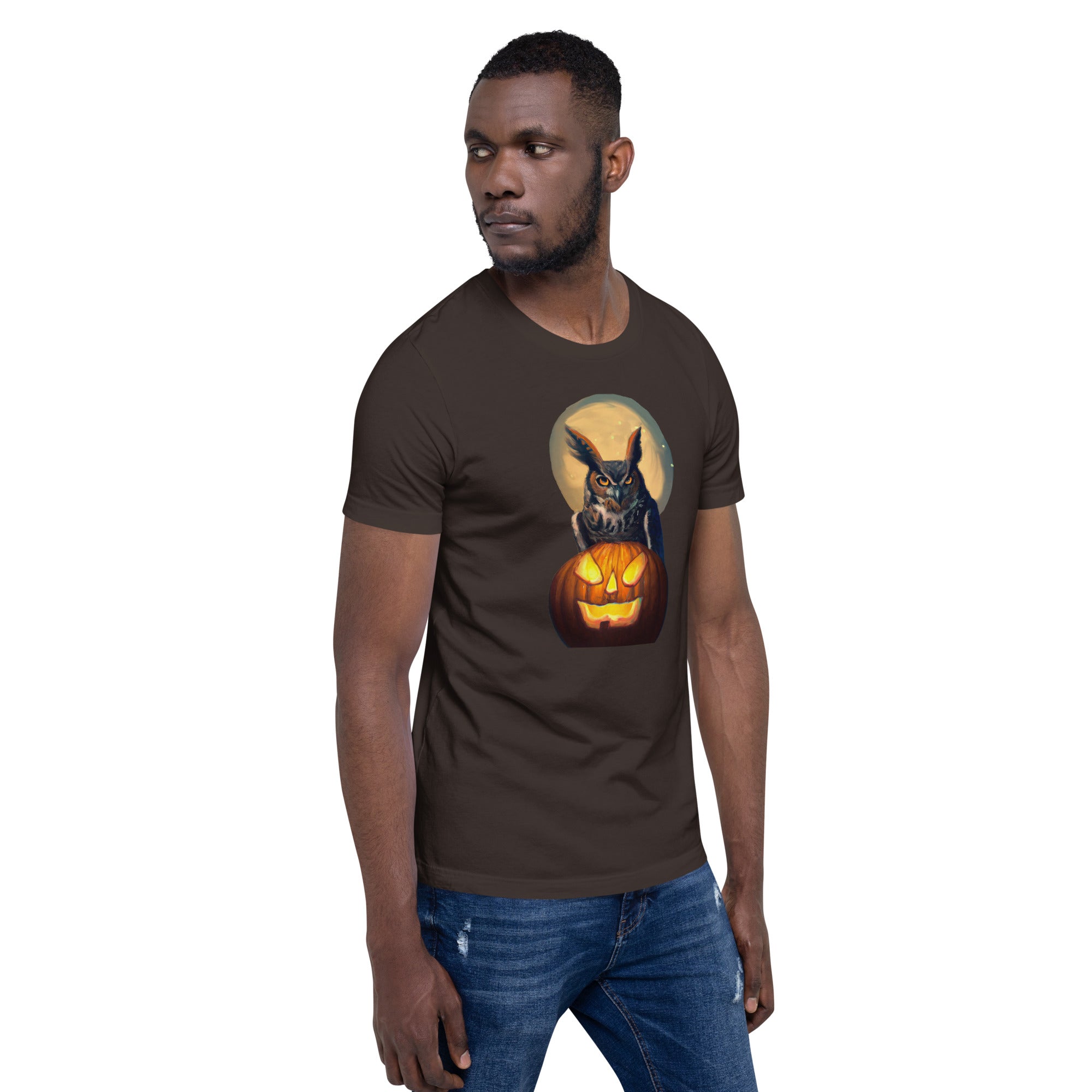 Brown bird t-shirt with a great horned owl sitting behind a jack-o-lantern with a full moon rising behind. Worn by a man.