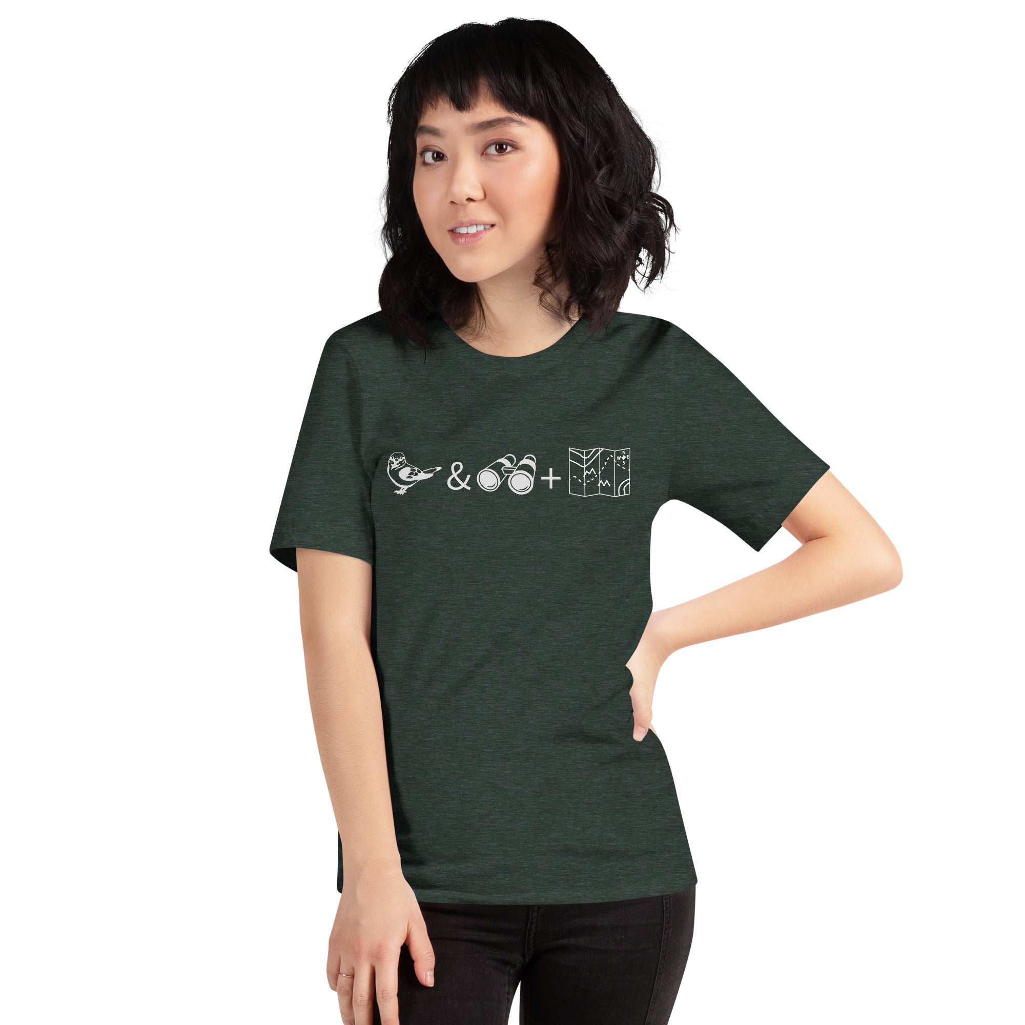 Unisex forest green heather bird t-shirt celebrating bird watching and the backcountry with a graphic of binoculars, a bird, and a map. Worn by a woman.