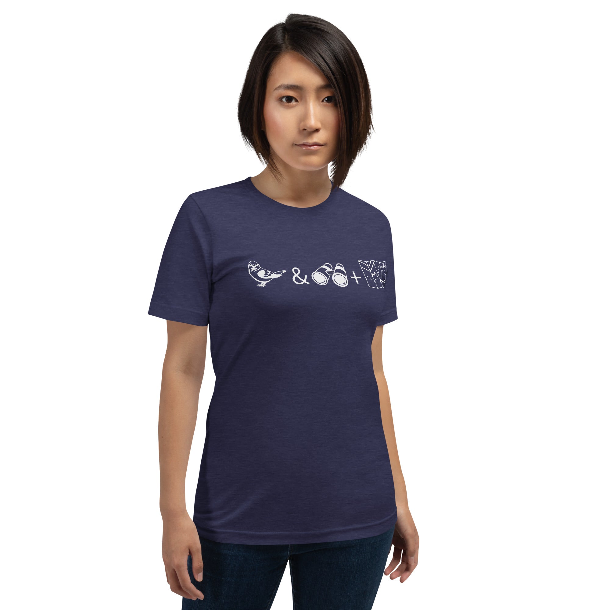 Unisex dark heather blue bird t-shirt celebrating bird watching and the backcountry with a graphic of binoculars, a bird, and a map. Worn by a woman.