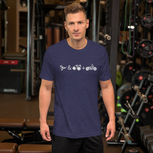 Unisex dark blue bird t-shirt celebrating bird watching and motorcycling with a graphic of binoculars, a bird, and a motorcycle. Worn by a man at the gym.