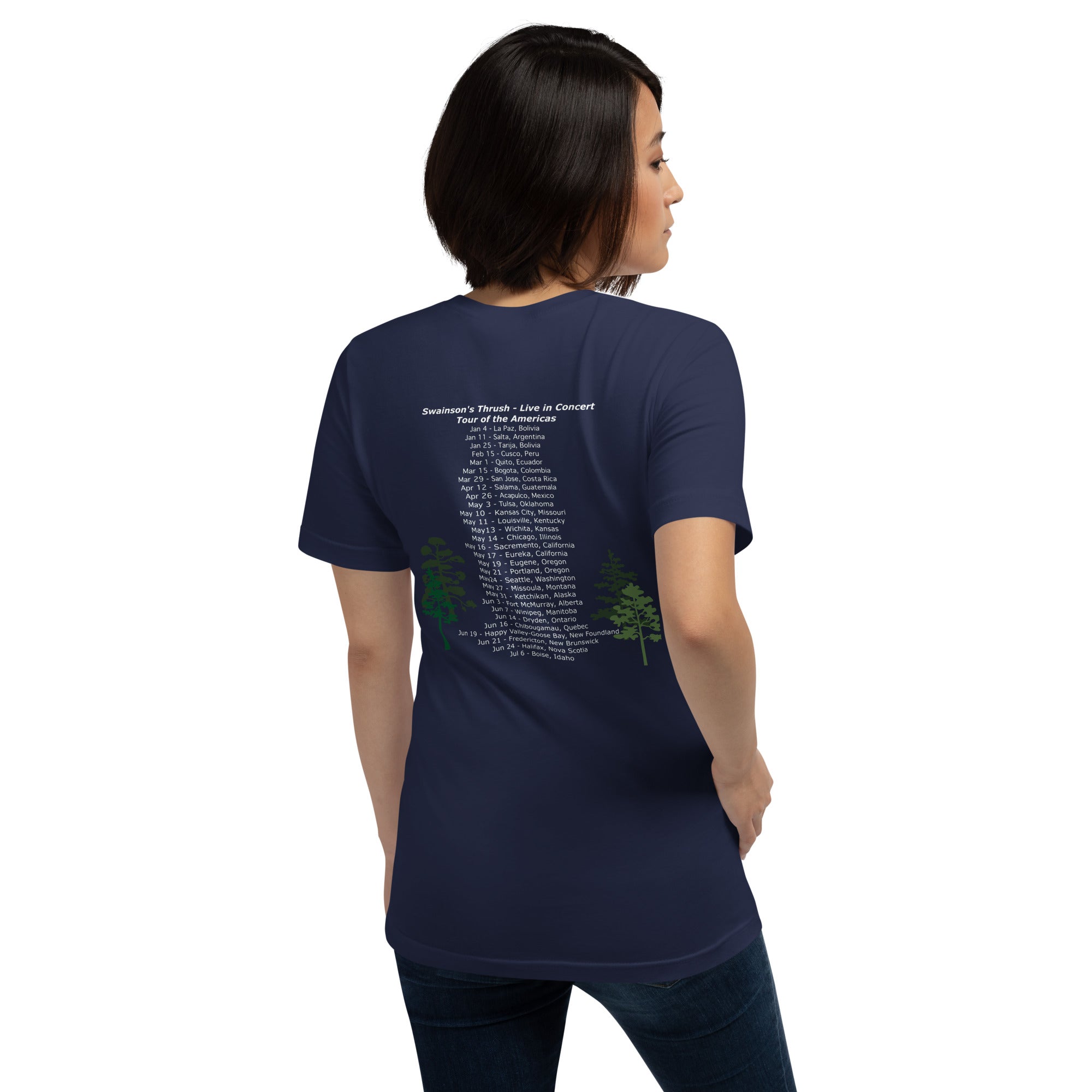 Navy unisex bird shirt mimicking a concert t-shirt with the words "Swainson's Thrush" and below that, "Tour of the Americas" and below that an illustrated Swainson's thrush singing into a microphone. Back of shirt, (shown) has concert dates and cities where this bird can be heard. Worn by a woman.