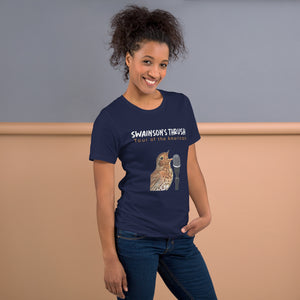 Navy unisex bird shirt mimicking a concert t-shirt with the words "Swainson's Thrush" and below that, "Tour of the Americas" and below that an illustrated Swainson's thrush singing into a microphone. Back of shirt, (not shown) has concert dates and cities where this bird can be heard.