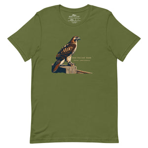 Green bird shirt with an artistic depiction of a red-tailed hawk sitting on a fence and the common and scientific names for the bird next to it.