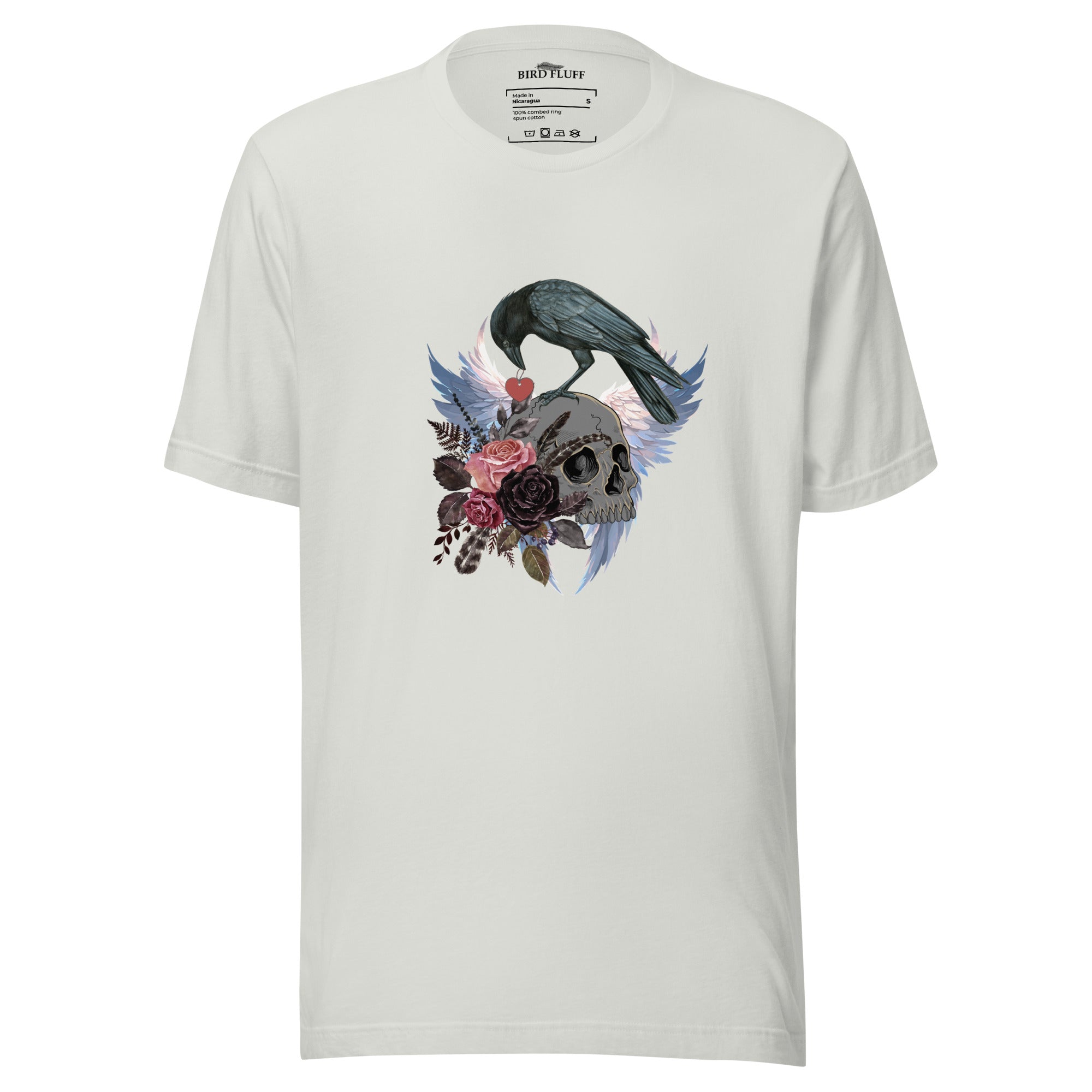 Gothic themed silver bird shirt with a crow carrying a heart pendant, perched on a skull surrounded by flowers, feathers and wings.