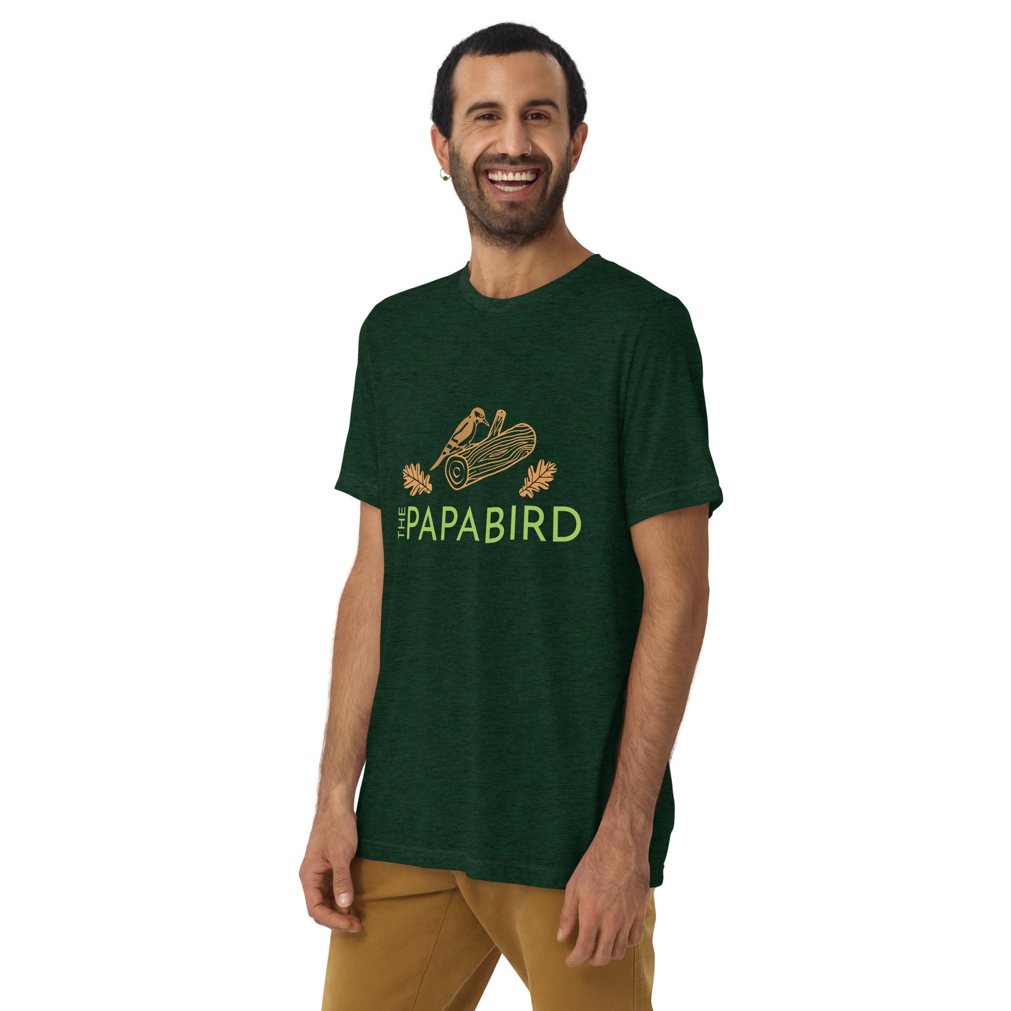 Dark green bird t-shirt with a graphic of a woodpecker on a log with some oak leaves and the text, "The Papa Bird" on the front, worn by a male model.