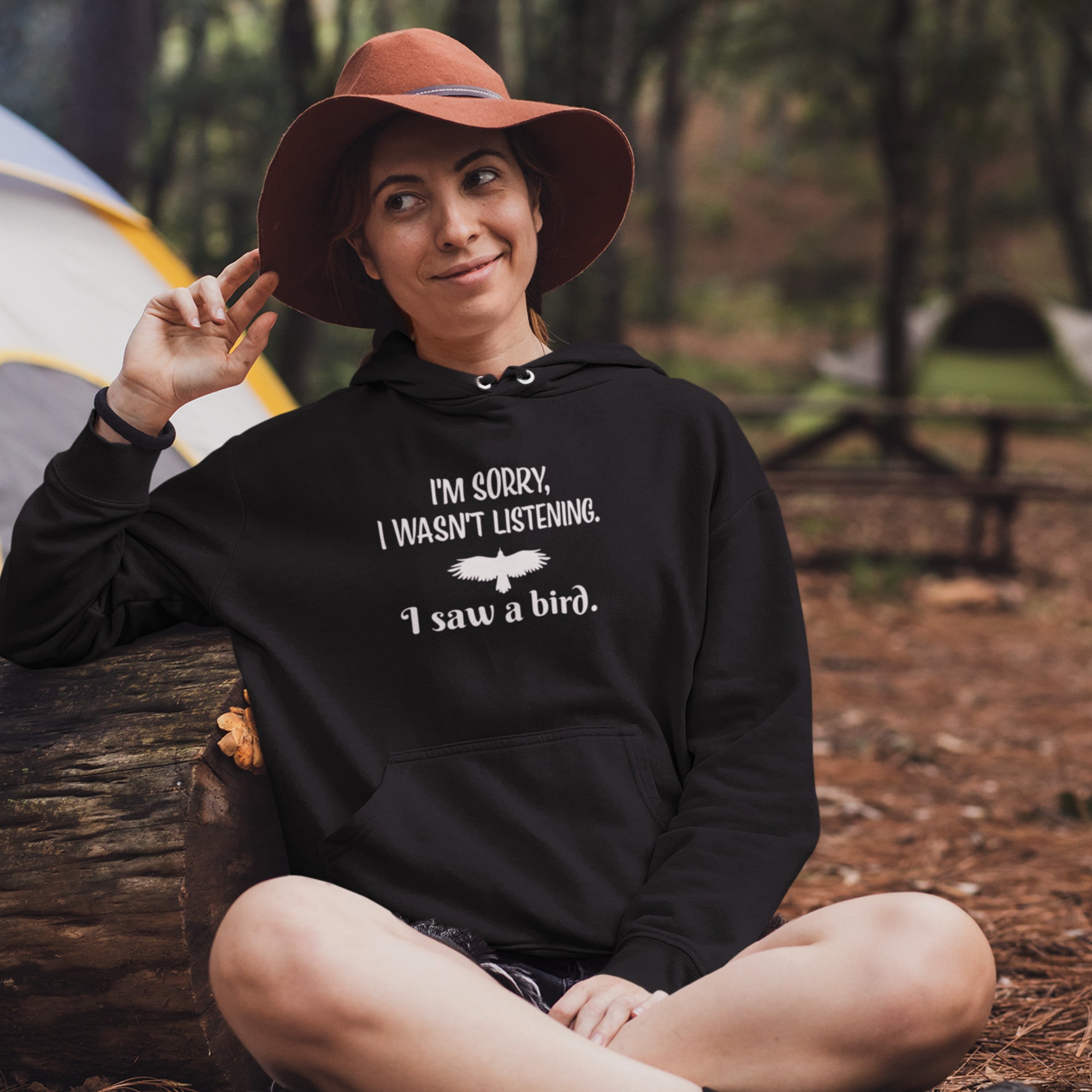 Black unisex bird hoodie with the words I'm sorry I wasn't listening, I saw a bird. And a graphic of a bird flying.