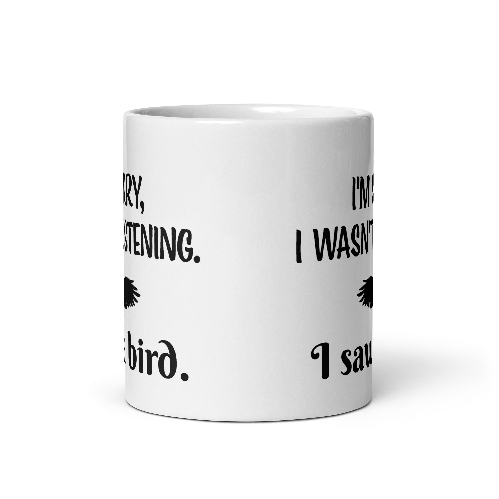 White 11oz mug with the words "I'm Sorry I Wasn't Listening. I Saw a Bird." around the silhouette of a bird flying.