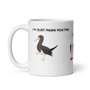 white glossy 11 ounce mug with illustrations of the blue-footed, red-footed and brown booby and the words, "I'm just here for the Sulidae." Mug handle to the left.