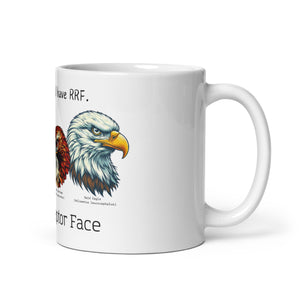 White 11oz mug with illustrations of a Great Horned Owl, Peregrine, Red-Tailed Hawk and Bald Eagle and the words "I'm Not Angry, I have RRF. Resting Raptor Face" above and below the birds..