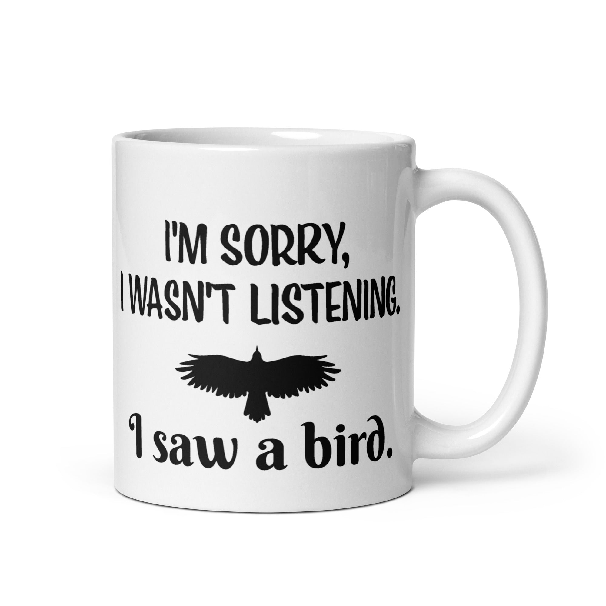 White 11oz mug with the words "I'm Sorry I Wasn't Listening. I Saw a Bird." around the silhouette of a bird flying.