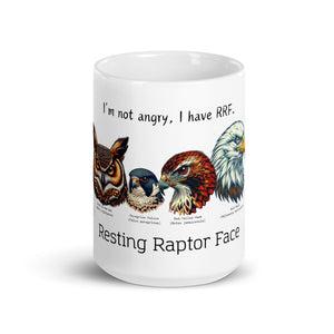 White 15oz mug with illustrations of a Great Horned Owl, Peregrine, Red-Tailed Hawk and Bald Eagle and the words "I'm Not Angry, I have RRF. Resting Raptor Face" above and below the birds.