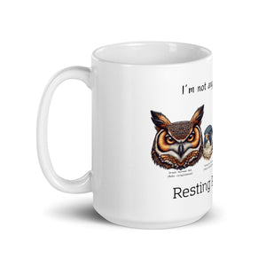 White 15oz mug with illustrations of a Great Horned Owl, Peregrine, Red-Tailed Hawk and Bald Eagle and the words "I'm Not Angry, I have RRF. Resting Raptor Face" above and below the birds.