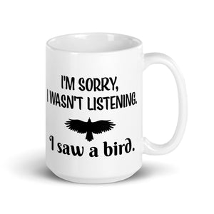 White 15oz mug with the words "I'm Sorry I Wasn't Listening. I Saw a Bird." around the silhouette of a bird flying.