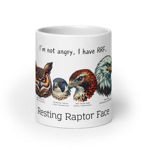 White 20oz mug with illustrations of a Great Horned Owl, Peregrine, Red-Tailed Hawk and Bald Eagle and the words "I'm Not Angry, I have RRF. Resting Raptor Face" above and below the birds..