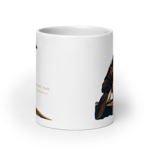 White 20oz mug with an illustration of a Red-Tailed Hawk on a fence and the common and scientific names next to the illustration.