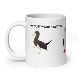 white glossy 20 ounce mug with illustrations of the blue-footed, red-footed and brown booby and the words, "I'm just here for the Sulidae." Mug handle to the left.