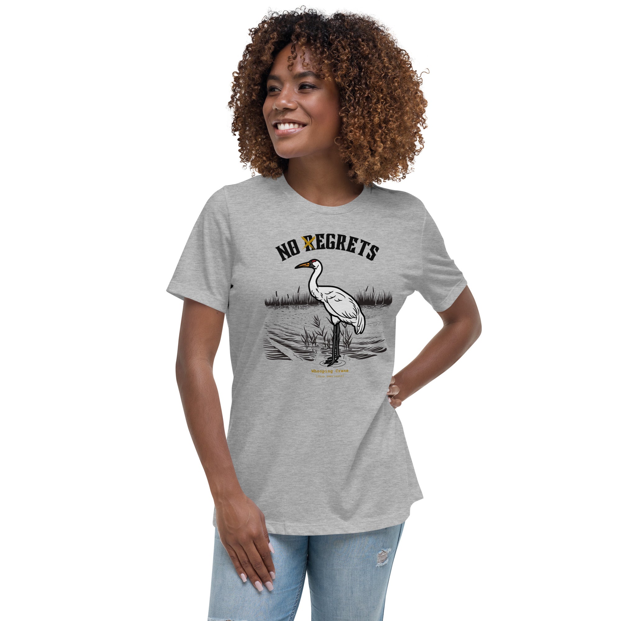 Light heather gray women's bird shirt featuring a play on the "No Regrets" tattoo that has the "R" crossed out to say "No Egrets" with a Whooping Crane below in a wetland setting. Worn by a woman.