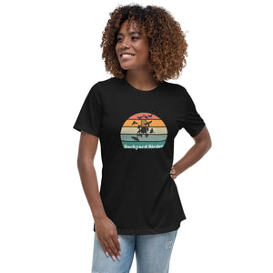 Black women's bird shirt with a retro sun design outlining a bird feeder with the words Backyard Birder. Worn by a woman.