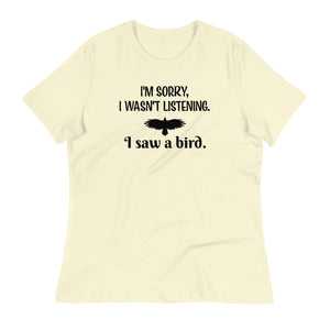 Light yellow women's bird t-shirt with the words I'm sorry I wasn't listening, I saw a bird. And a graphic of a bird flying.