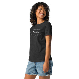 Dark heather gray women's bird t-shirt with the words Birdsong feeds my soul placed above and below a white graphic of 4 birds on a branch. Worn by a woman.