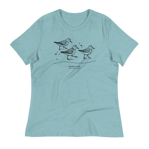 Light heather blue bird shirt featuring an illustration of a three sanderlings on a beach and the common and scientific names for the bird underneath.