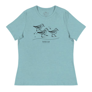 Light heather blue bird shirt featuring an illustration of a three sanderlings on a beach and the common and scientific names for the bird underneath.