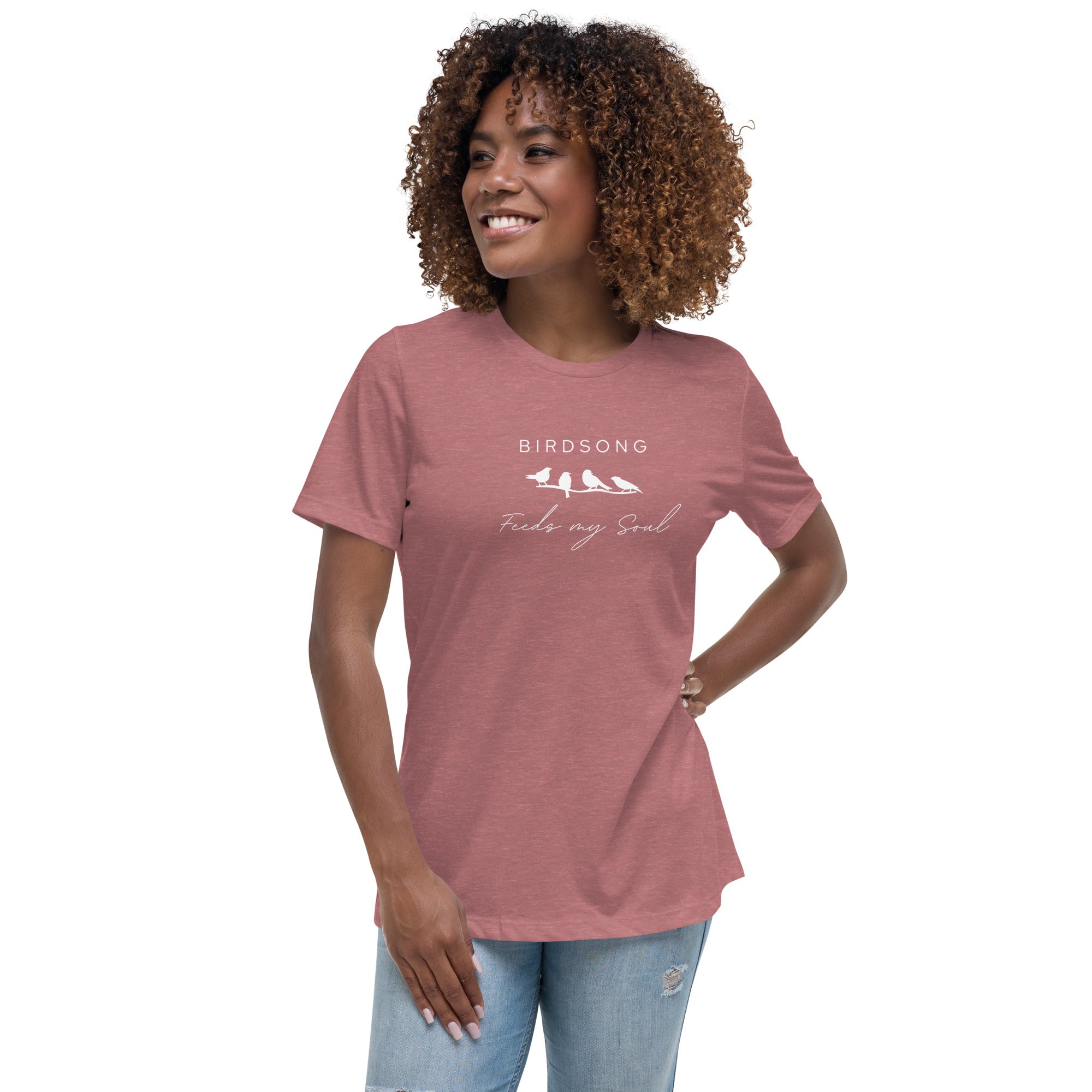 Heathered mauve women's bird t-shirt with the words Birdsong feeds my soul placed above and below a white graphic of 4 birds on a branch. Worn by a woman.