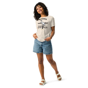 Natural weathered off white women's bird shirt featuring a play on the "No Regrets" tattoo that has the "R" crossed out to say "No Egrets" with a Whooping Crane below in a wetland setting. Worn by a woman.