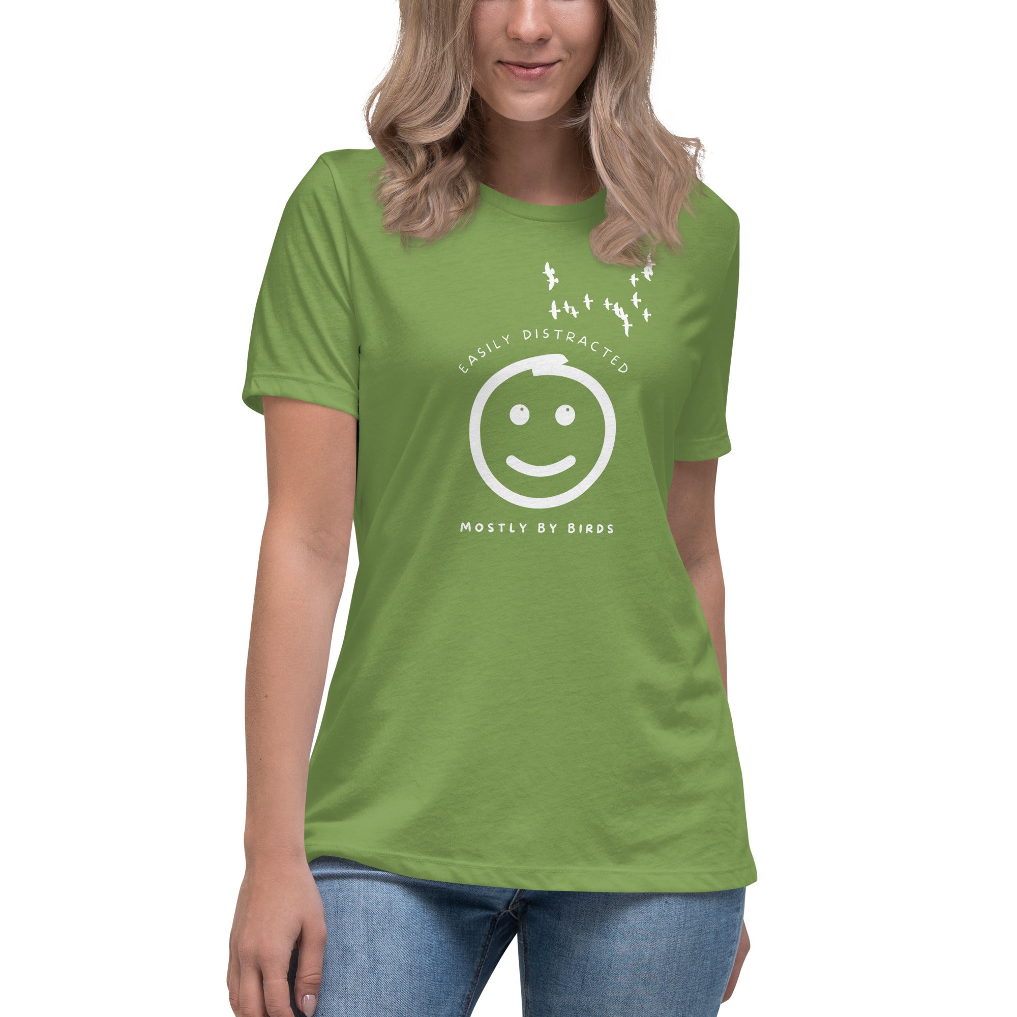 Light green women's bird t-shirt with a smiley face looking up and to the side at a flock of birds surrounded by the words, "Easily Distracted" above and, "Mostly by Birds" below. Worn by a woman.