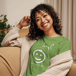 Leaf green women's bird t-shirt with a smiley face looking up and to the side at a flock of birds surrounded by the words, "Easily Distracted" above and, "Mostly by Birds" below. Worn by a woman.