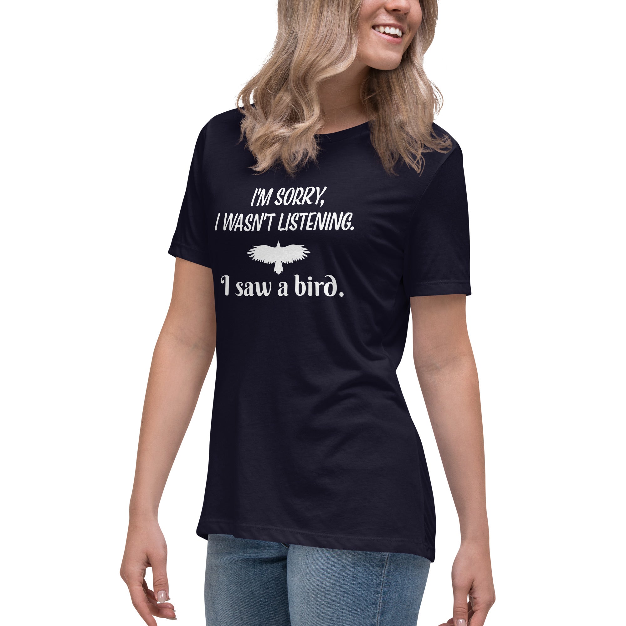 Navy blue women's bird t-shirt with the words I'm sorry I wasn't listening, I saw a bird. And a graphic of a bird flying. Worn by a woman.