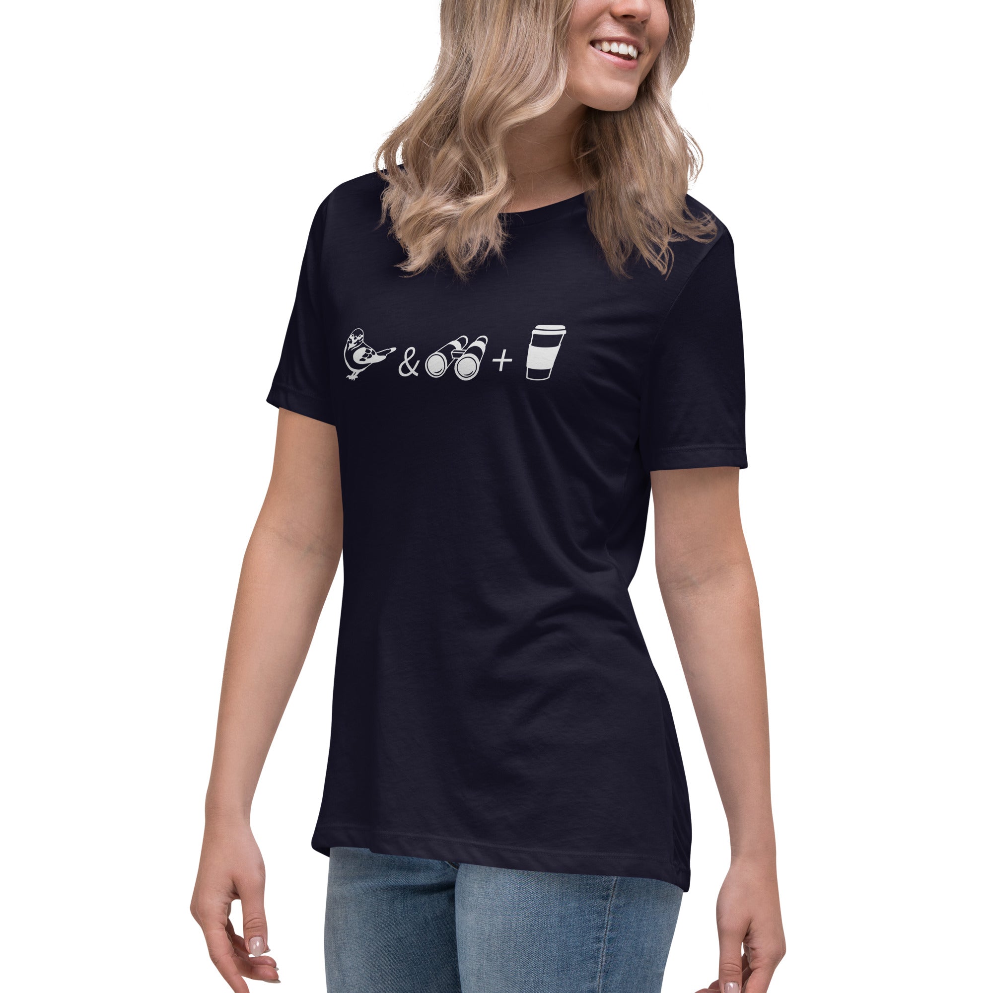 Navy blue women's bird t-shirt celebrating bird watching and coffee with a graphic of binoculars, a bird, and a travel cup of coffee. Worn by a woman.