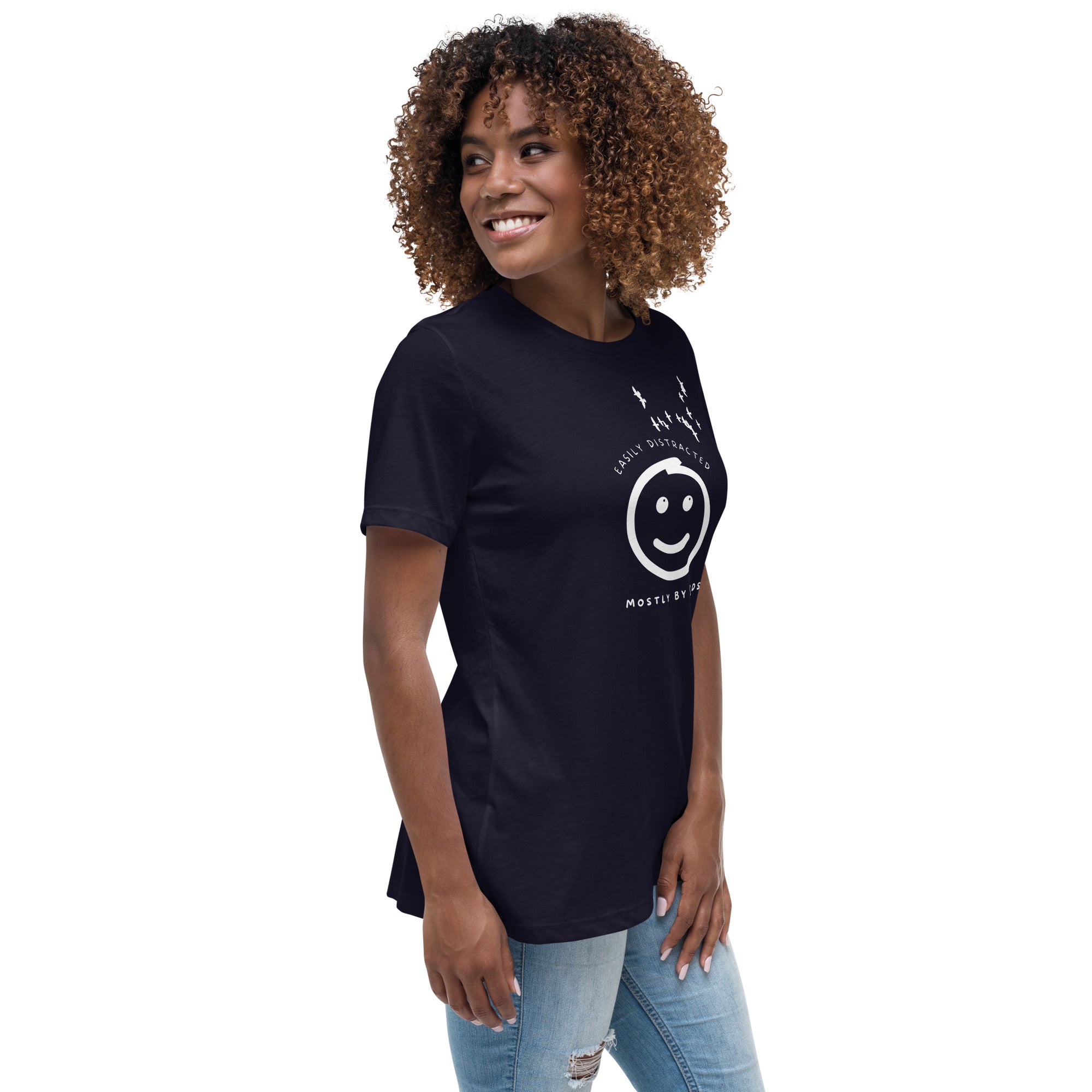 Navy blue women's bird t-shirt with a smiley face looking up and to the side at a flock of birds surrounded by the words, "Easily Distracted" above and, "Mostly by Birds" below. Worn by a woman.