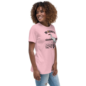 Pink women's bird shirt featuring a play on the "No Regrets" tattoo that has the "R" crossed out to say "No Egrets" with a Whooping Crane below in a wetland setting. Worn by a woman.