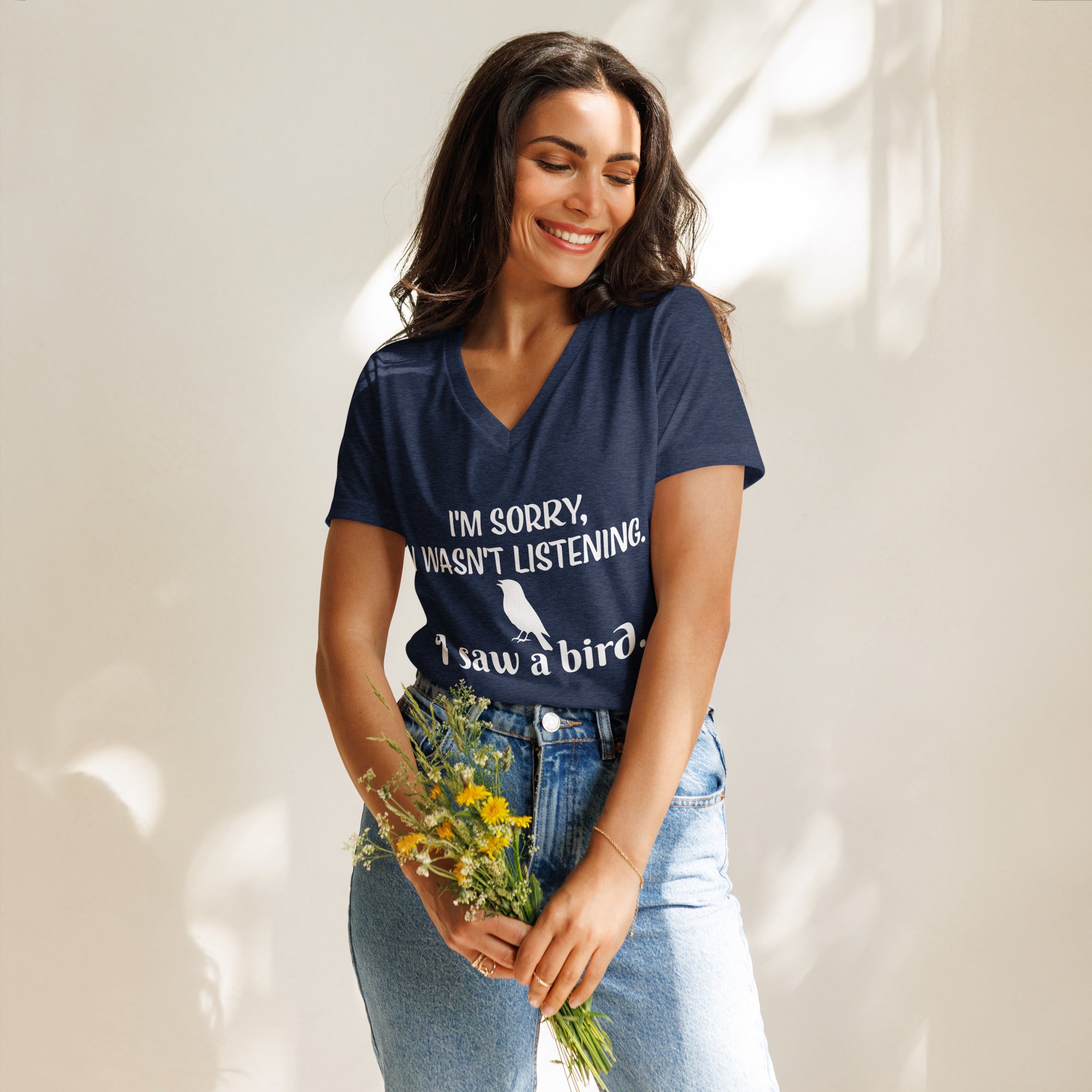 Heather navy women's relaxed v-neck bird t-shirt with the words I'm sorry I wasn't listening, I saw a bird. And a graphic of a songbird.