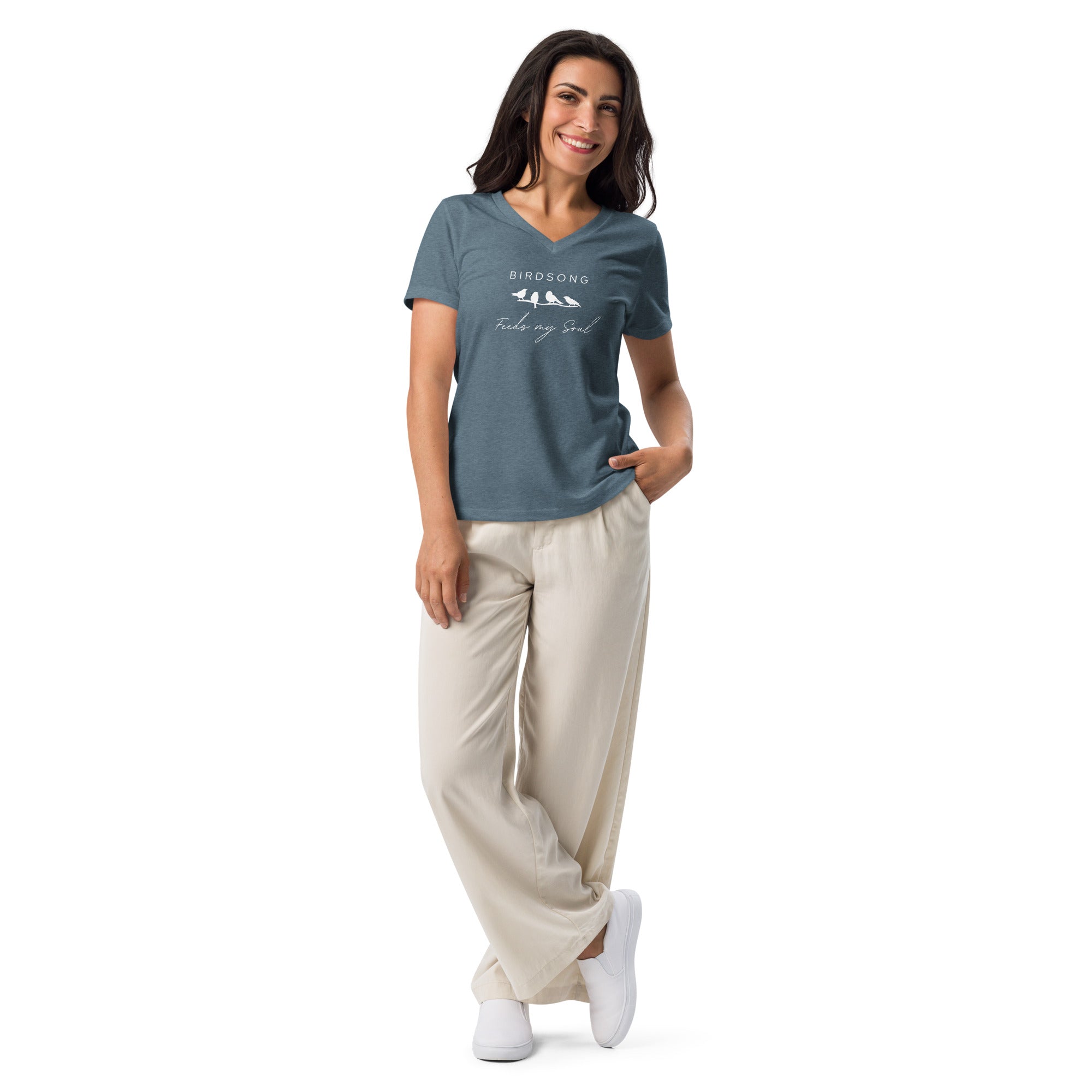 Slate blue heather women's v-neck bird t-shirt with the words Birdsong feeds my soul placed above and below a white graphic of 4 birds on a branch. Worn by a woman.