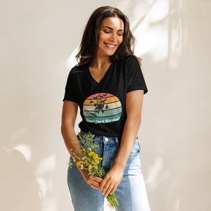 Black women's v-neck bird shirt with a retro sun design outlining a bird feeder with the words Backyard Birder. Worn by a woman.