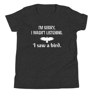 Dark heather grey youth bird t-shirt with the words I'm sorry I wasn't listening, I saw a bird. And a graphic of a bird flying.