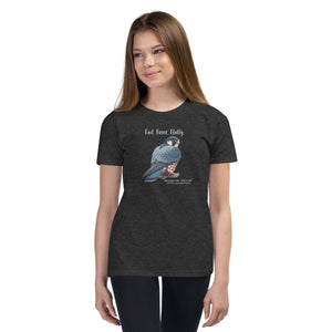 A dark heather grey youth bird shirt with the words, "Fast. Fierce. Fluffy" above an illustration of a peregrine falcon. Worn by a girl.