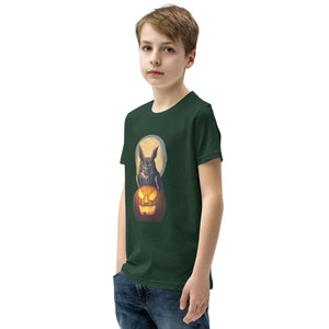 Forest green youth bird t-shirt with a great horned owl sitting behind a jack-o-lantern with a full moon rising behind. Worn by a boy.