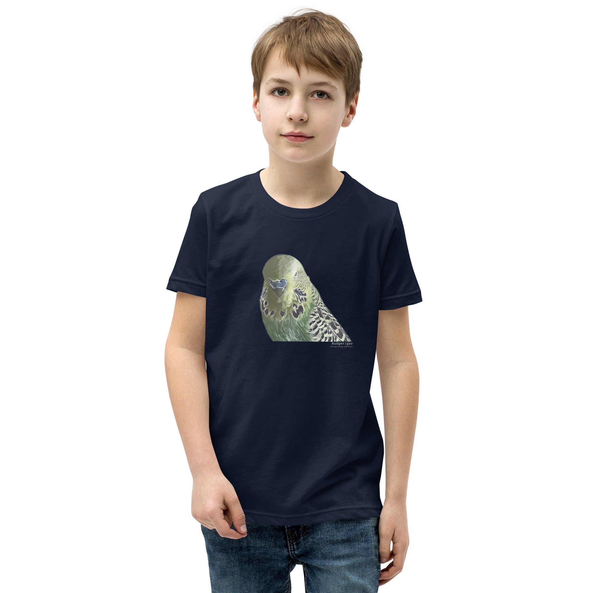 Navy unisex youth bird t-shirt with an illustrated and lifelike graphic of a green and yellow parakeet or budgie on the front. Below and to the right of the picture is the word Budgerigar and below that the scientific name in parenthesis in small print. Worn by a boy.