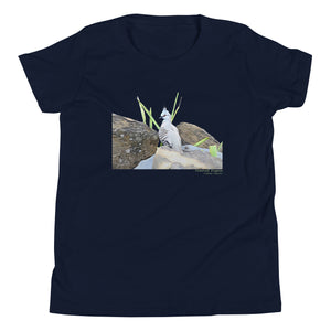 Navy unisex youth bird t-shirt with a graphic of a crested pigeon among some rocks and grass on front, and the words crested pigeon written below and the scientific name below that.