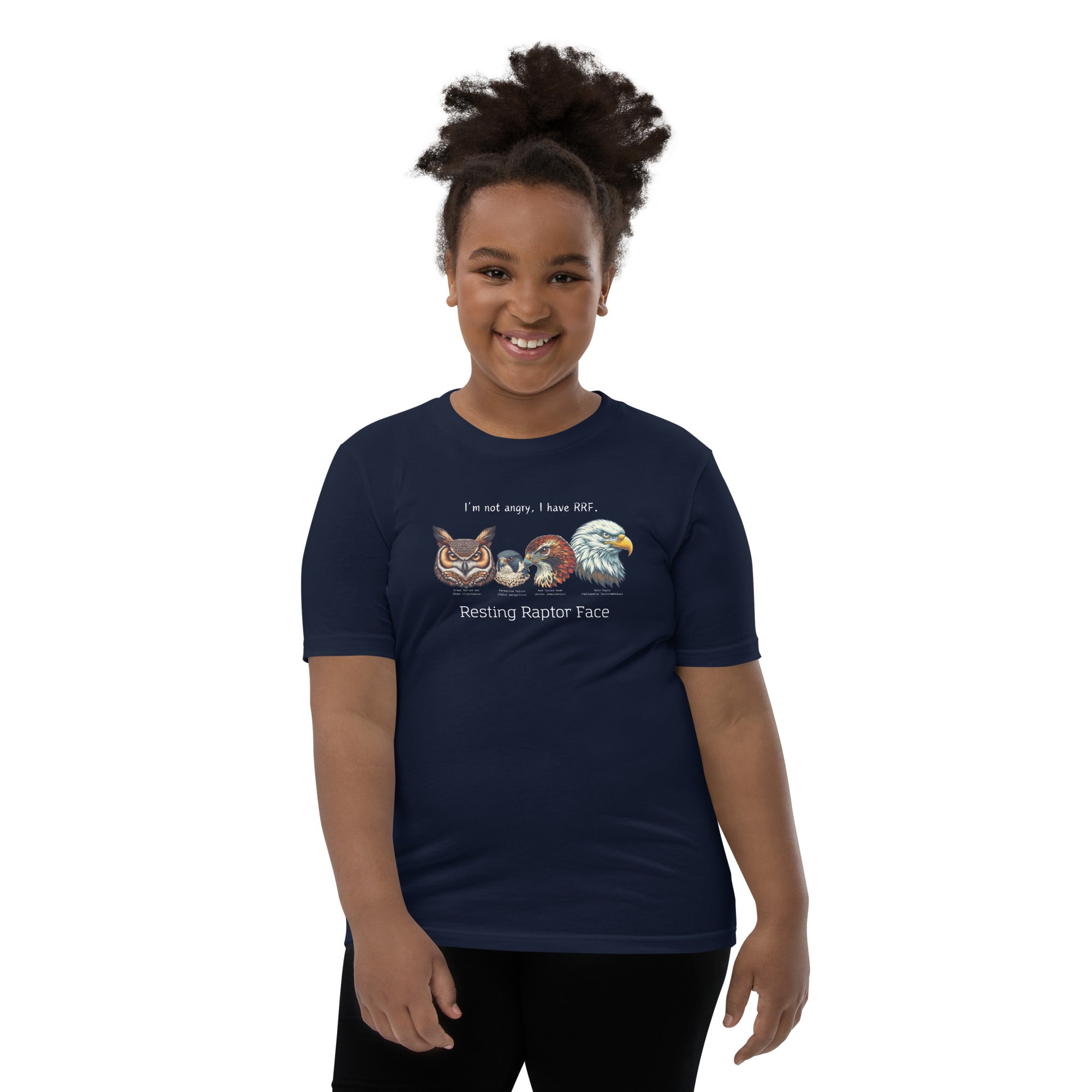 A navy youth bird shirt with a great horned owl, a peregrine falcon, a red-tailed hawk and a bald eagle. The shirt has text that says, I'm not angry, I have RRF. Resting Raptor Face. Worn by a girl.