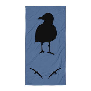 Blue large beach towel with a large silhouette of a sea gull on a branch and two smaller flying gull silhouettes beneath.