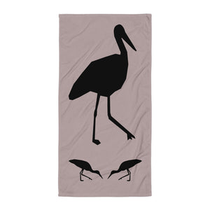 Dusty purple large beach towel with a large silhouette of a stork on a branch and two smaller stork silhouettes beneath.