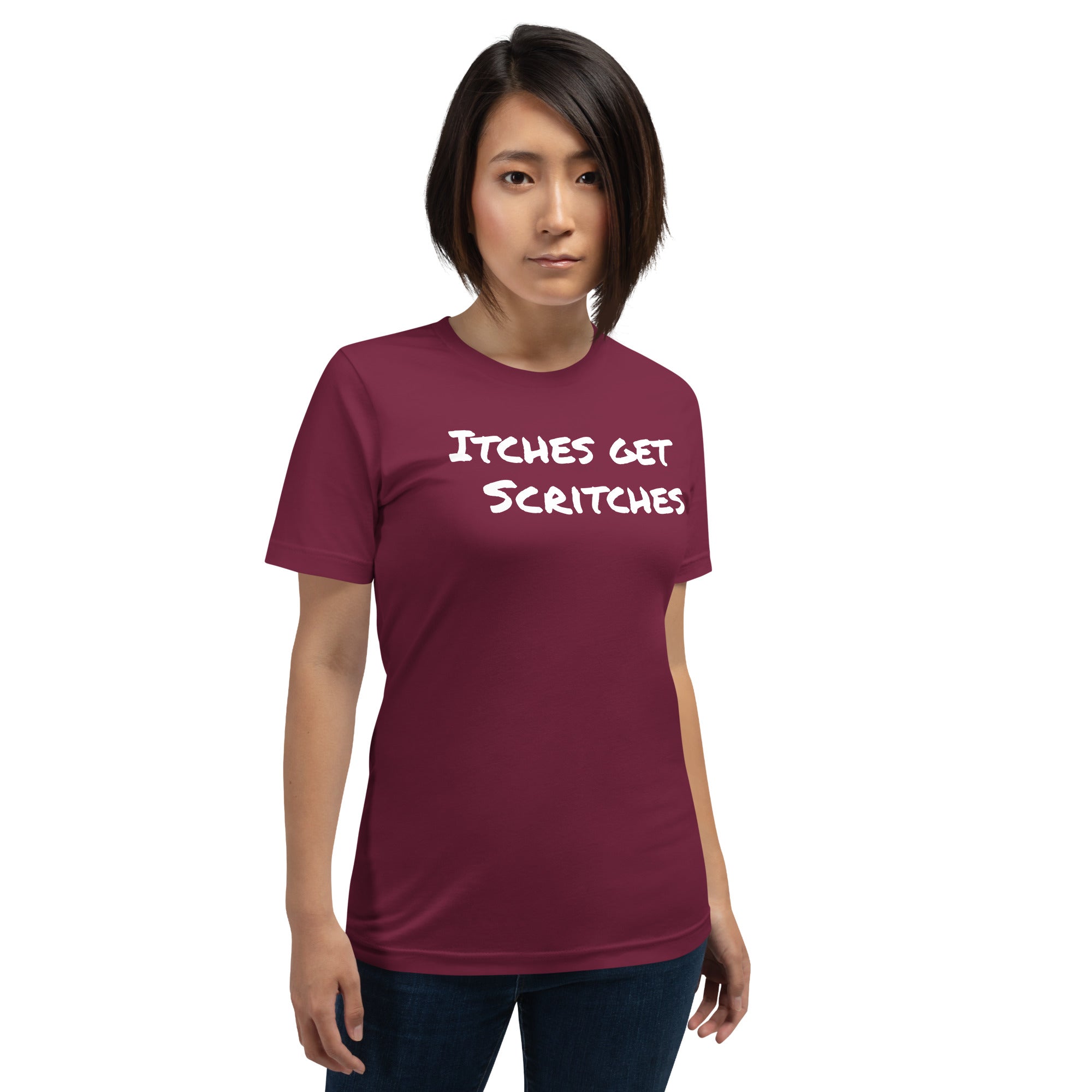 Maroon unisex t-shirt with the phrase, "Itches get scritches" across the front. Worn by female model.